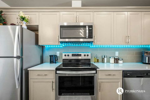 Sleek modern kitchen with stainless steel appliances and ambient lighting