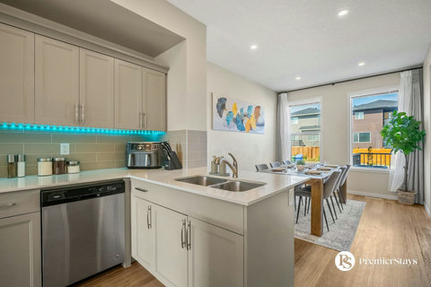 Bright, modern kitchen with island and open dining space overlooking the neighborhood
