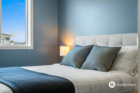 Serene master bedroom with soft linens and warm ambient lighting