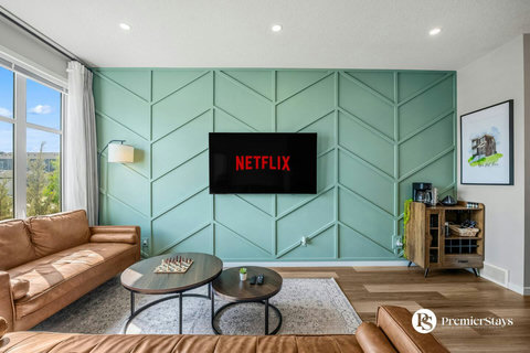 Stylish living room featuring mint geometric accent wall and entertainment setup