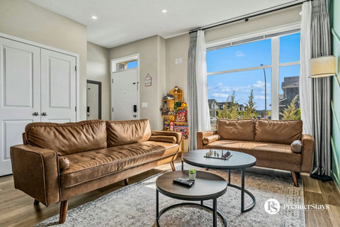 Spacious living room with stunning views of the neighborhood skyline