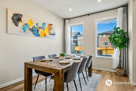 Bright dining space with wooden table overlooking the neighborhood