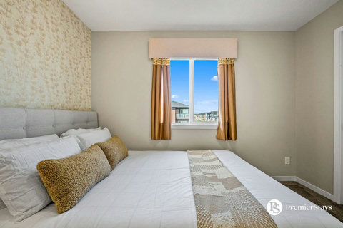 Comfortable master bedroom with expansive city views and natural light