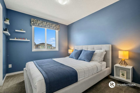 Cozy blue guest bedroom with natural light and quality bedding