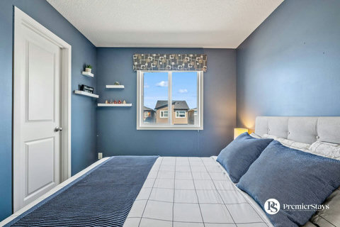 Comfortable guest bedroom with cheerful blue décor and natural light
