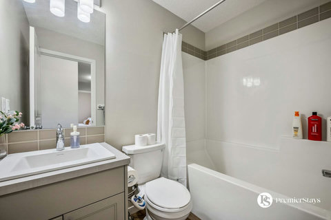 Bright and clean bathroom with shower, tub, and ample counter space
