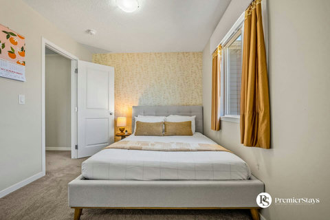 Bright guest bedroom with elegant gold accents and comfortable bedding