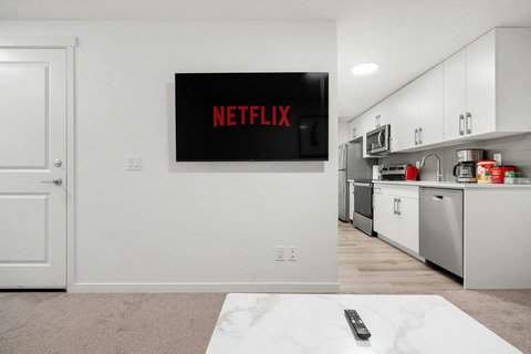 Comfortable living space with entertainment and modern kitchen access