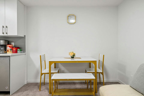 Stylish dining space with contemporary gold-framed furniture and marble table