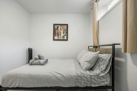 Bright, airy guest bedroom with crisp striped linens and modern styling