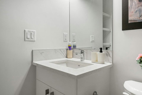 Sleek guest bathroom with marble accents and ample counter space