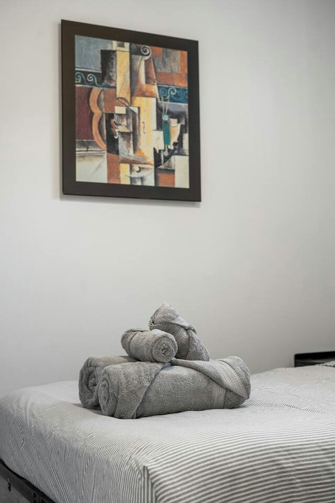 Thoughtfully styled bedroom with fresh linens and curated wall art