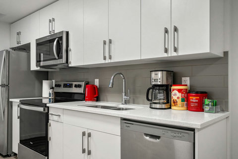 Fully equipped modern kitchen with stainless steel appliances and ample counter space