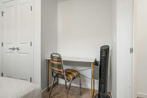 Cozy guest bedroom featuring a dedicated work desk and modern amenities