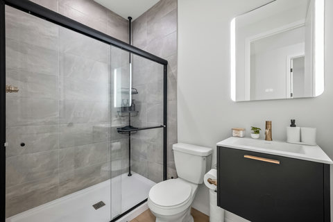 Sleek modern bathroom featuring a spacious walk-in shower and elegant vanity