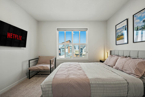 Bright master bedroom with comfortable king bed and scenic window views