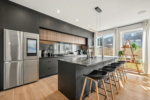 Sleek modern kitchen with premium stainless steel appliances and island seating.
