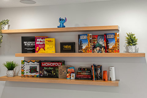 Curated board game collection and decorative shelving in shared space