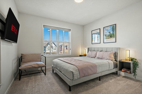 Comfortable guest bedroom with natural light and modern furnishings