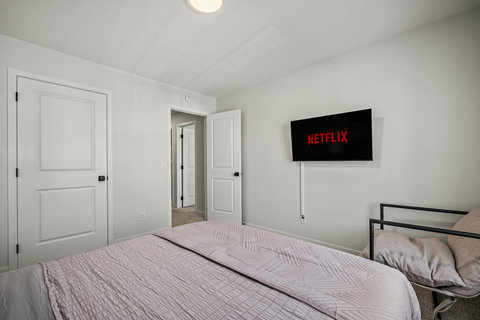 Comfortable guest bedroom with entertainment and modern amenities