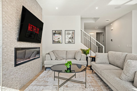 Spacious living room with modern fireplace, comfortable seating, and entertainment setup