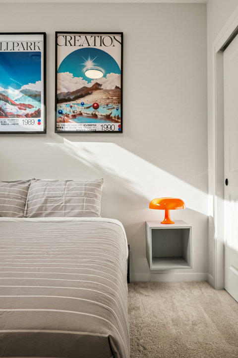 Serene guest bedroom flooded with natural light and curated art