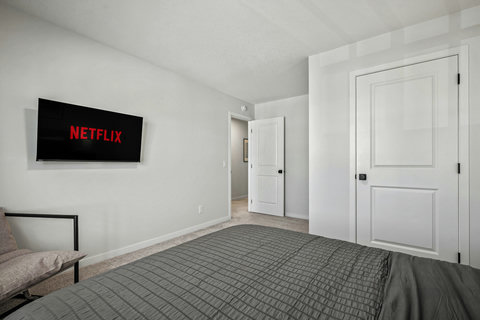 Comfortable guest bedroom with entertainment and plenty of storage