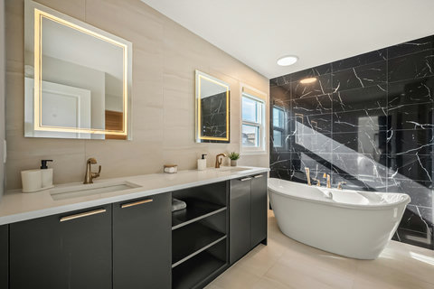Spa-like master bathroom with soaking tub and elegant marble finishes