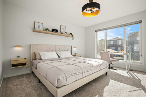 Spacious master bedroom with private balcony overlooking the neighborhood