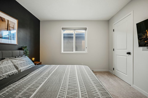 Comfortable guest bedroom with modern amenities and plenty of natural light
