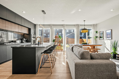 Bright open-plan living area with modern kitchen and comfortable seating
