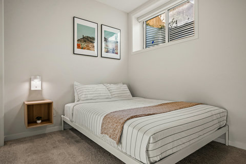 Cozy guest bedroom with natural light and thoughtful coastal decor touches
