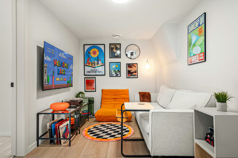 Playful retro gaming lounge with vintage arcade vibes and bold orange details