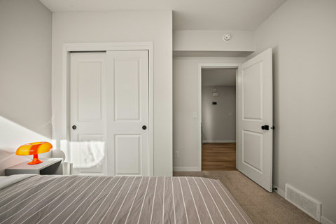 Comfortable guest bedroom with ample storage and natural light