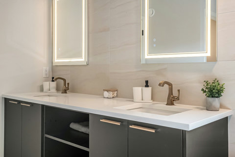 Luxurious dual vanity bathroom with ambient lighting and elegant finishes