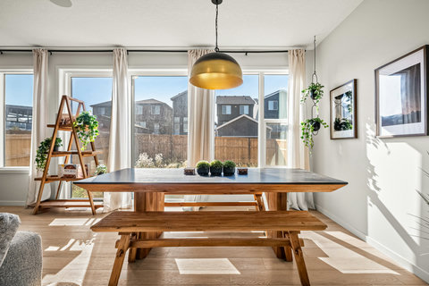 Bright dining space with stunning backyard views and natural light