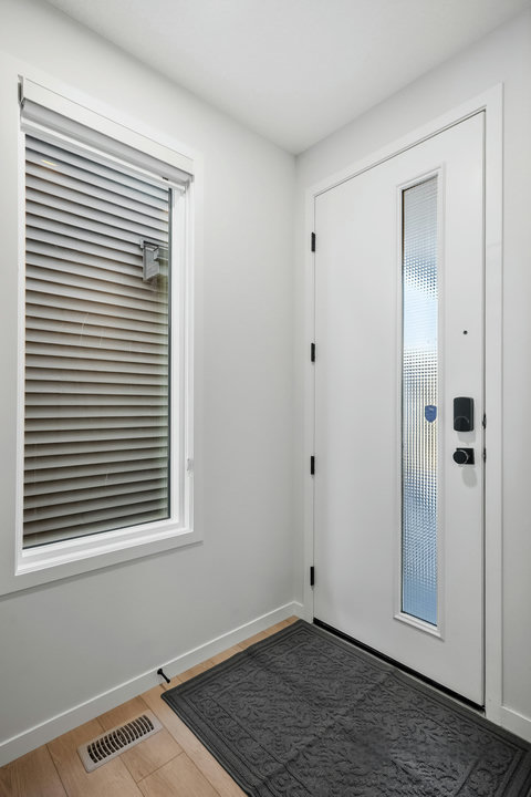 Bright, welcoming entryway with smart lock access and natural light