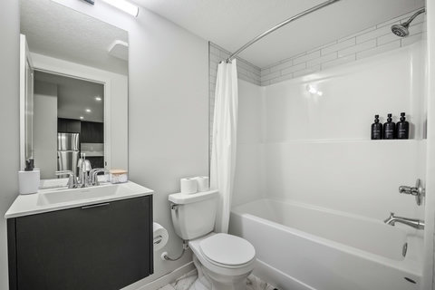 Sleek modern bathroom with plenty of storage and contemporary finishes.