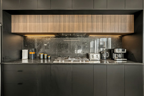 Sleek contemporary kitchen featuring gas cooking and elegant marble surfaces