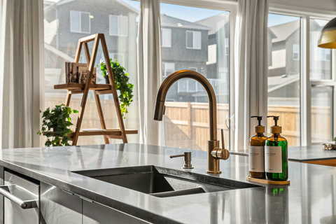 Bright modern kitchen with sleek island sink and expansive windows