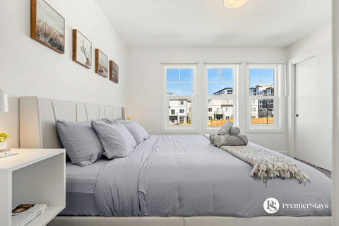 Spacious master bedroom flooded with natural light and views