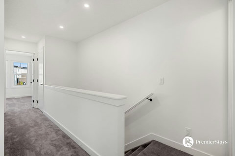 Clean, well-lit hallway with modern finishes and convenient handrails