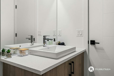 Sleek modern bathroom featuring dual vessel sinks and contemporary finishes