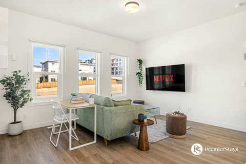 Bright, airy living room with comfortable seating and entertainment
