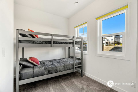 Comfortable guest bedroom with twin bunk beds and natural light.