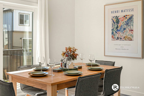Elegant dining space with natural light and contemporary artwork