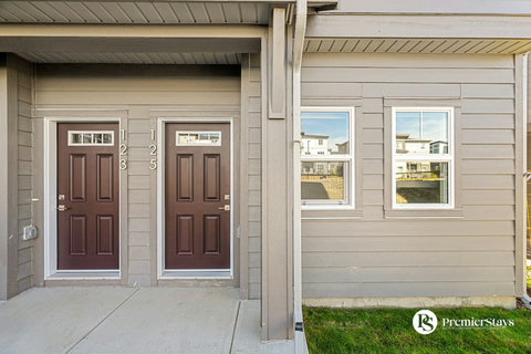 Welcoming front entrance with dual doors and bright windows overlooking the neighborhood