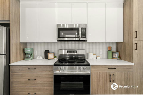 Fully equipped modern kitchen with stainless steel appliances and ample counter space
