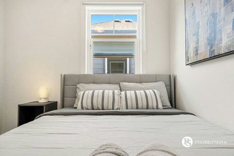 Serene guest bedroom filled with natural light and modern furnishings