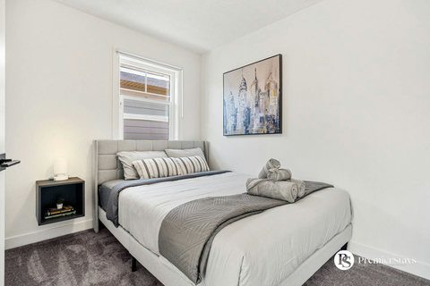 Comfortable guest bedroom with soft linens and modern furnishings